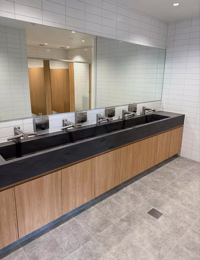 Amenities with trough basin and timber vanity cleaned by Tier1Clean