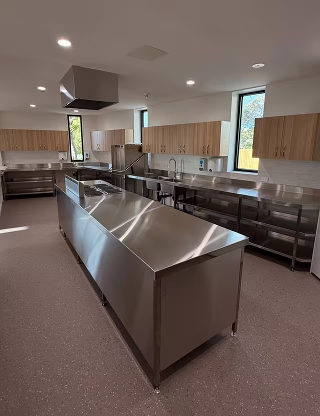 Commercial kitchen with stainless benches cleaned by Tier1Clean