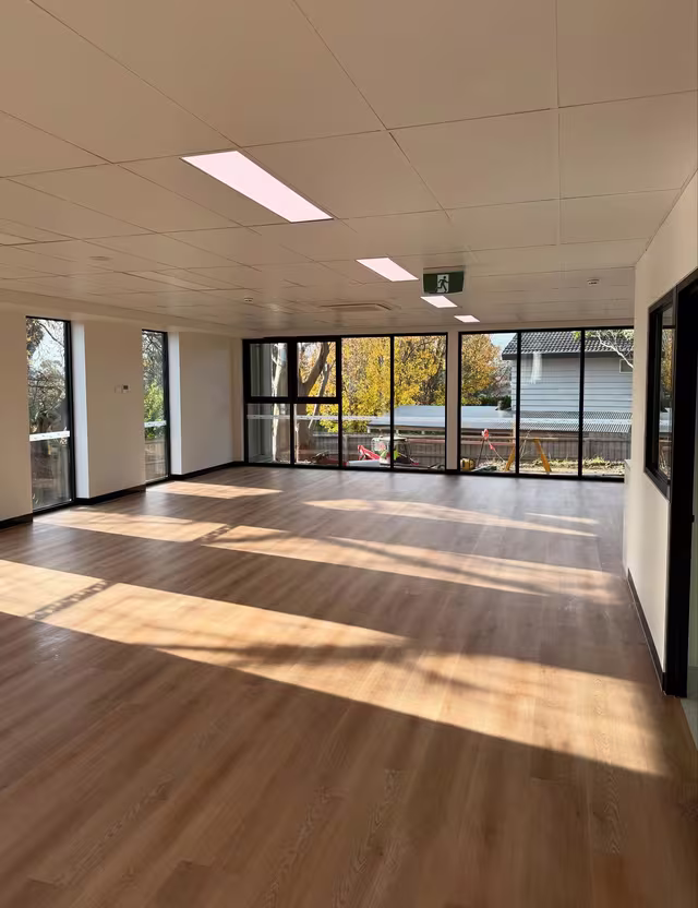 Full height glazing and timber floor cleaned by Tier1Clean